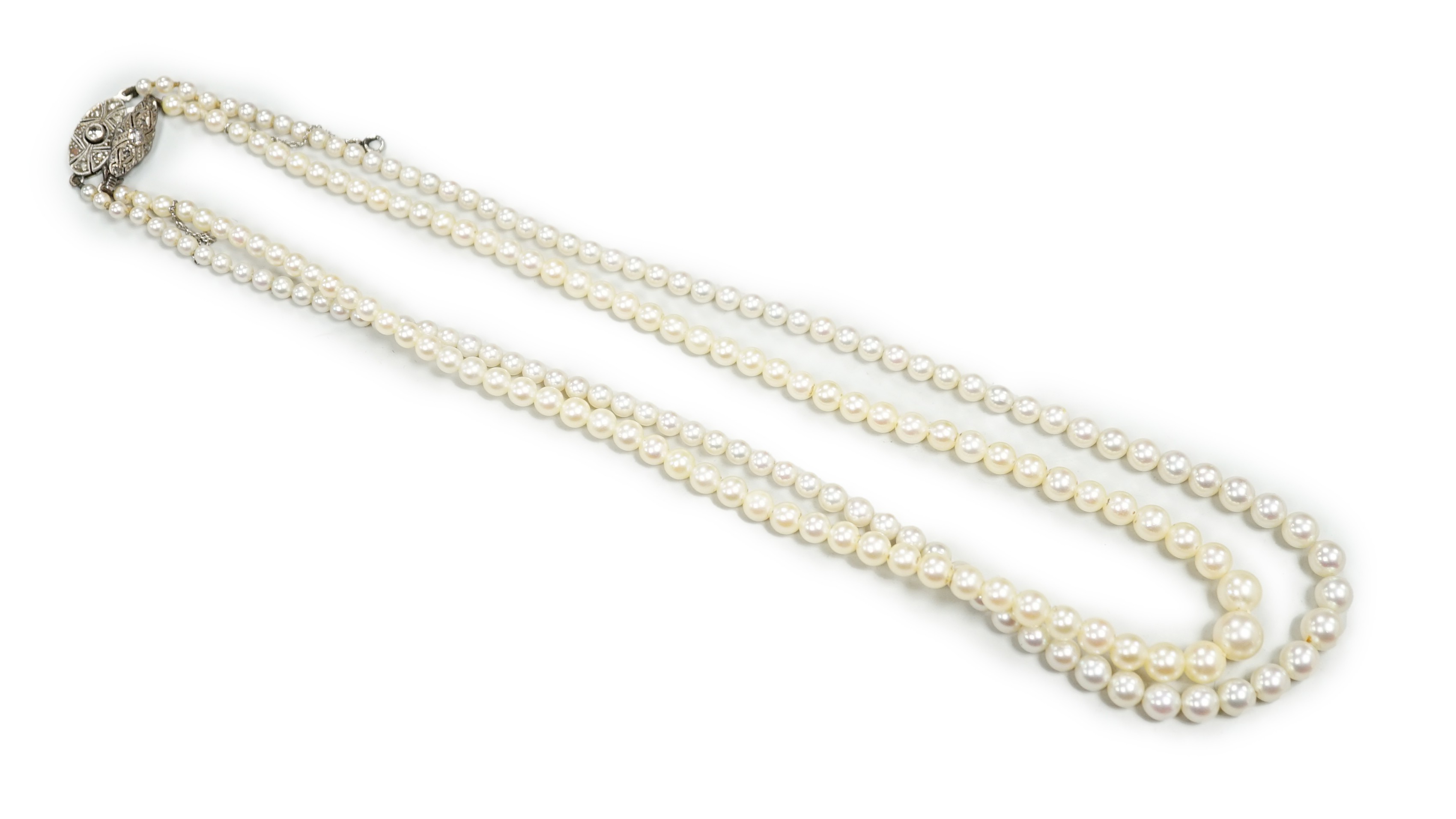 Two single strand graduated cultured pearl necklaces, both with diamond set white or yellow metal clasps, 39cm and 44cm.